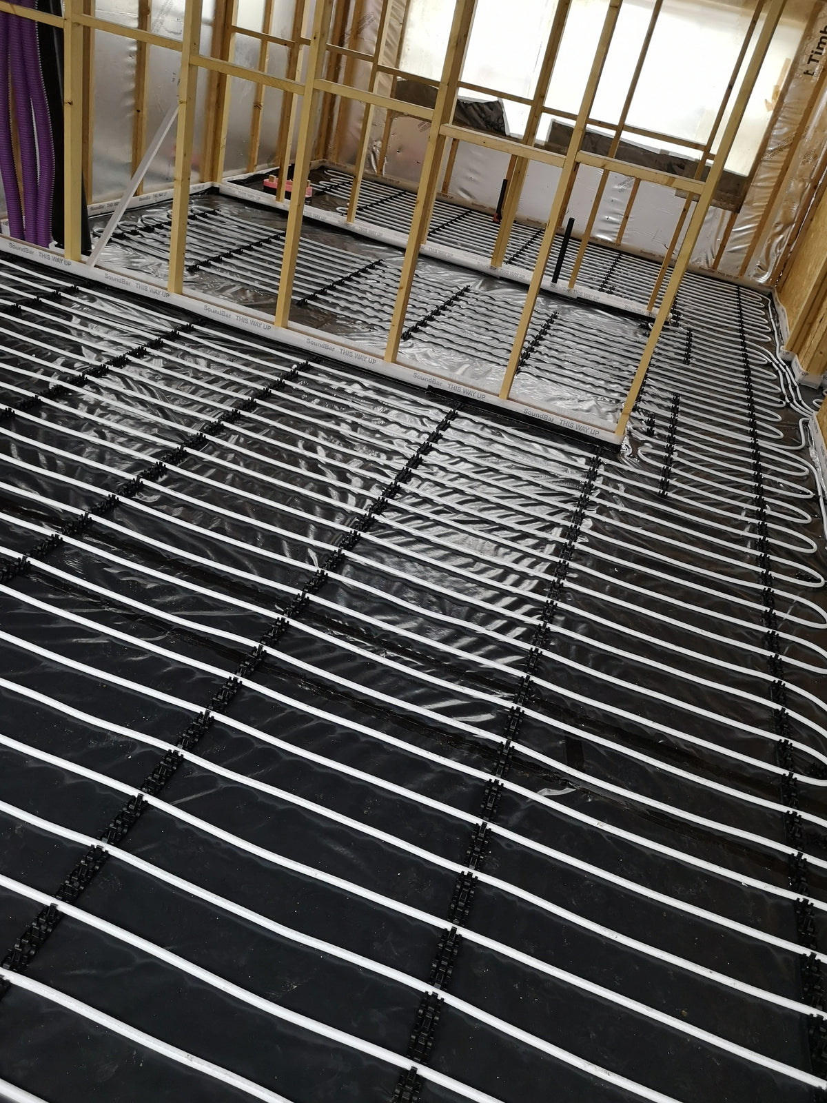 Underfloor heating circuits routed through upper-floor rooms