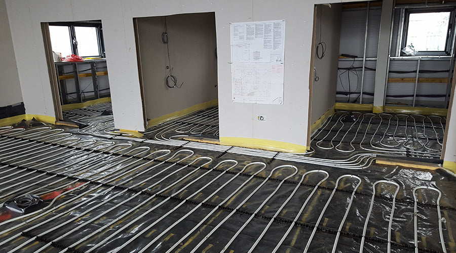Underfloor heating circuits routed through adjoining rooms at Skoda West End Garage