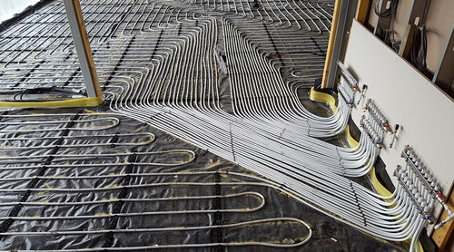 Underfloor heating pipework laid across the open commercial floor